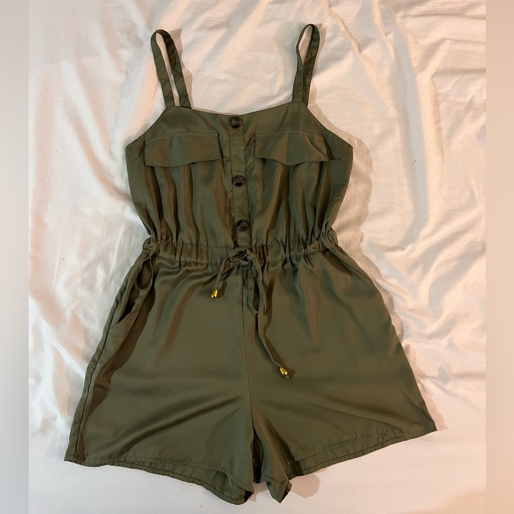 Green women’s romper with adjustable straps. Size Large